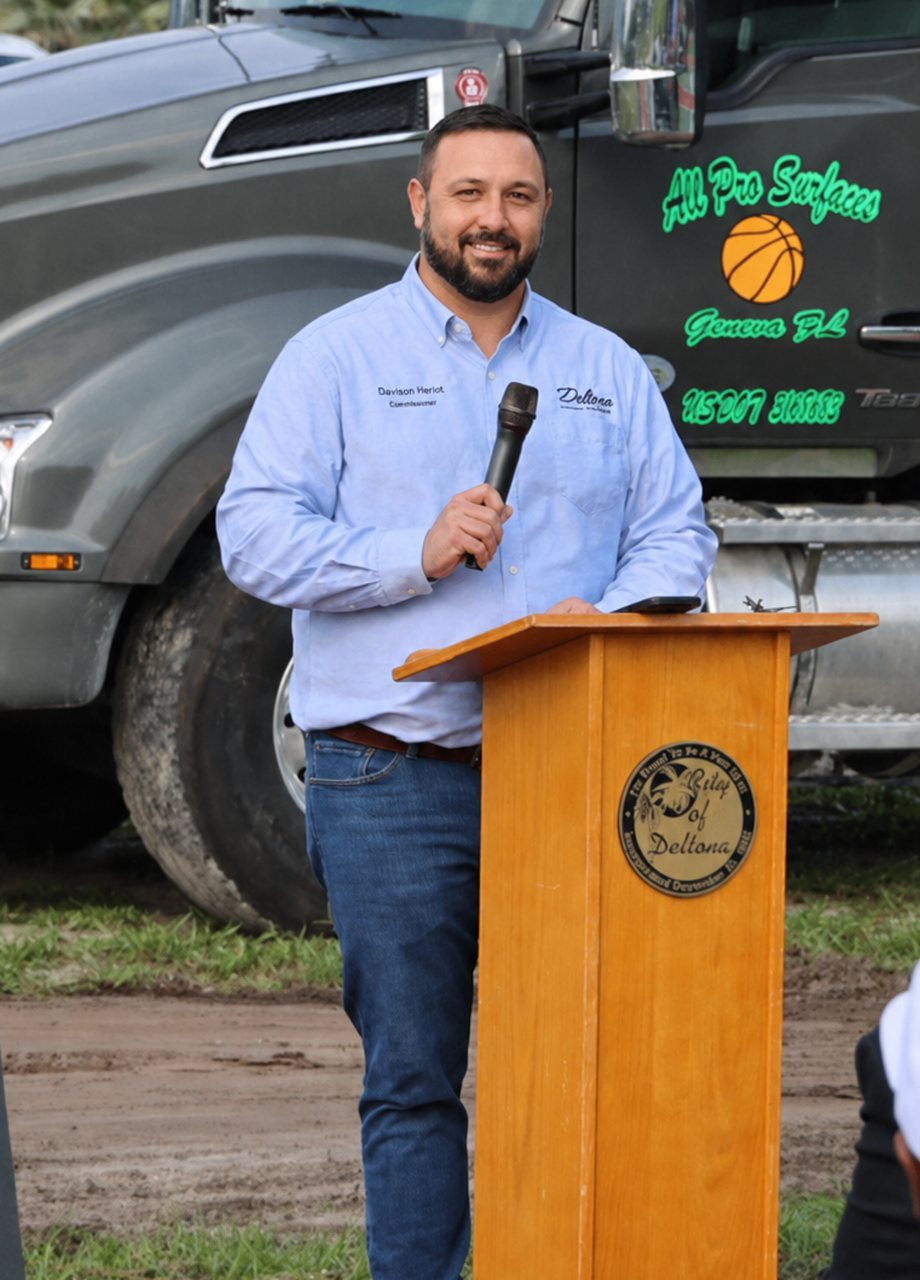 Davison Heriot speaking at a City of Deltona podium